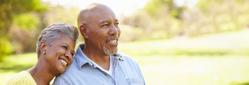 African American couple smiles after the male partner enters remission from prostate cancer. 