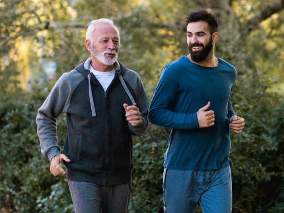Senior man jogging with his son