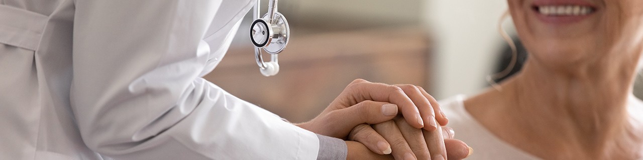 Patient and physician holding hands