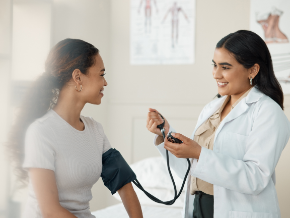 Doctor taking patient's blood pressure