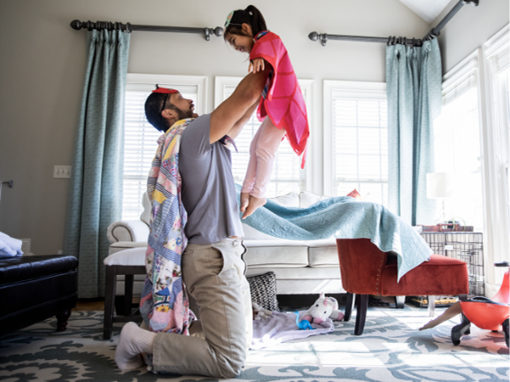 Father and daughter celebrate heart month by playing a game together.