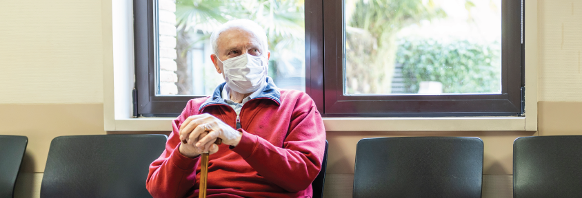 A man sits in an emergency waiting room