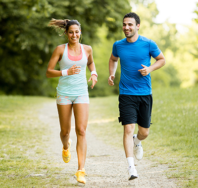 Two people running and smiling