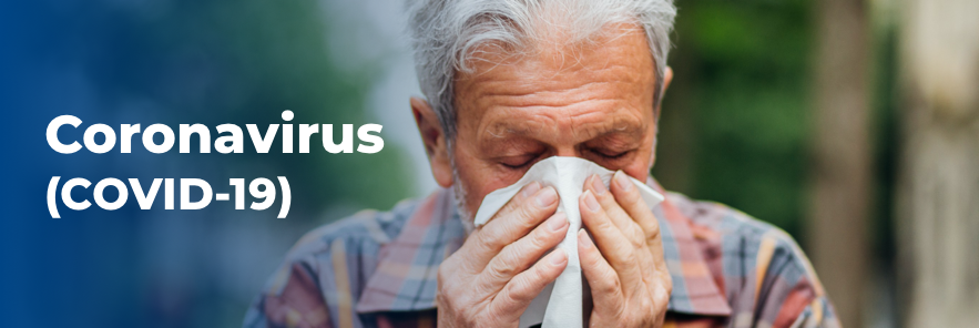 Elderly man covering face with handkerchief