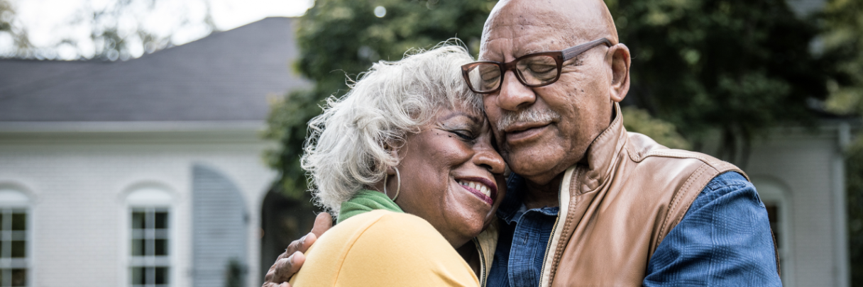 A woman hugs her spouse after he returns home from receiving high-quality stroke care.