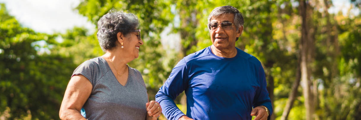 A married couple goes on an afternoon walk to keep up a healthy lifestyle.