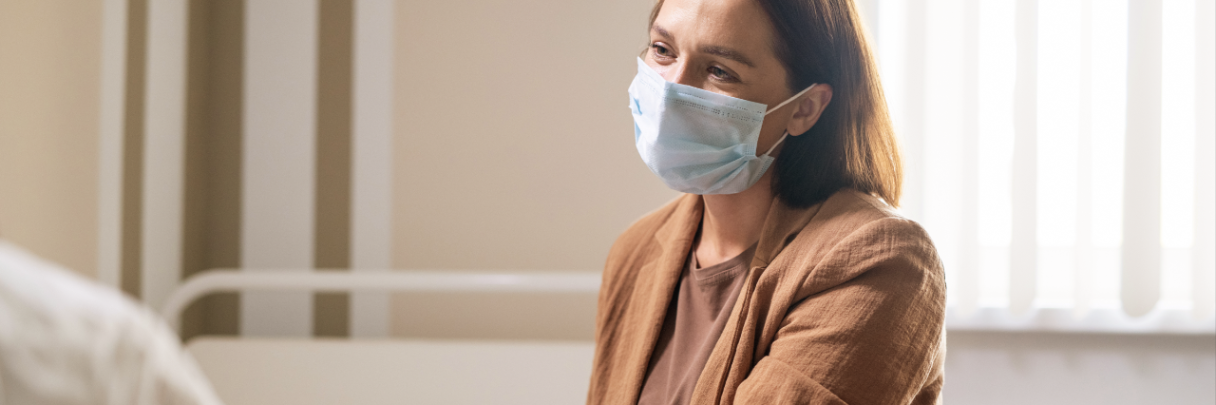 A woman visits her family member in the hospital during visiting hours.