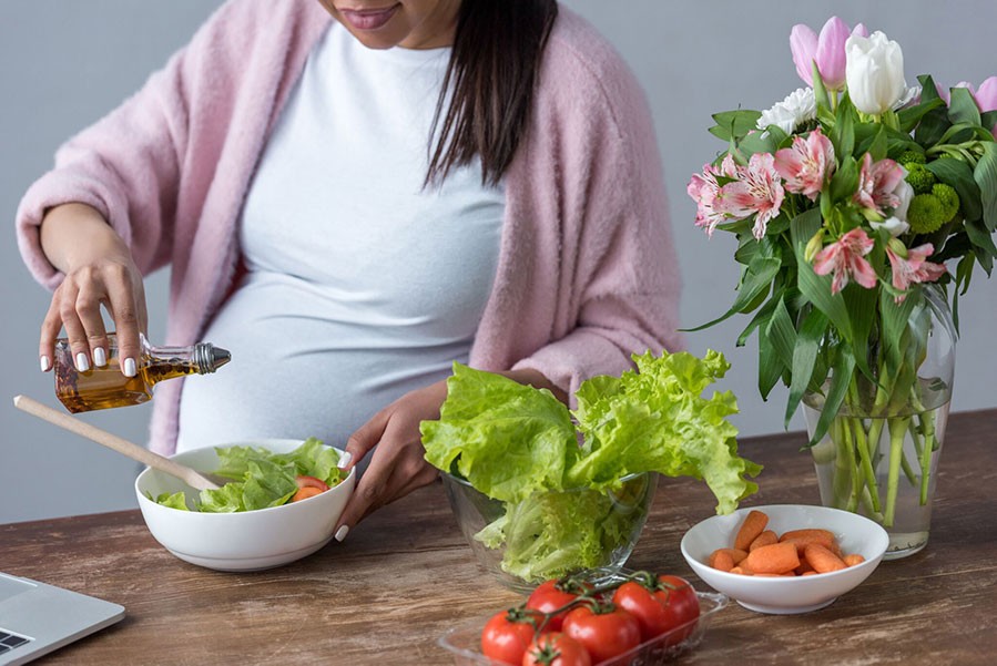 Pregnant woman eating a salad