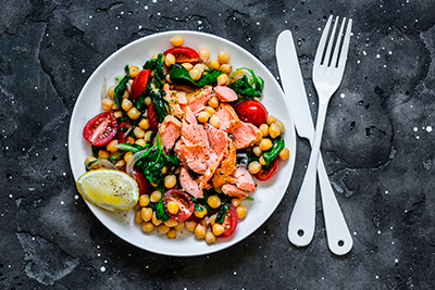Mediterranean salmon and chickpea salad with homemade dressing, a meatless dish for Lent
