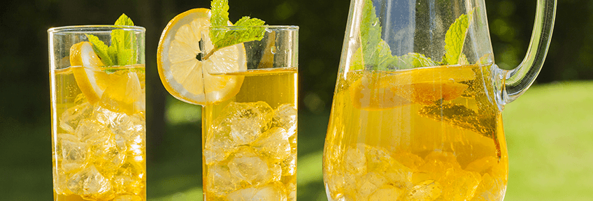 Healthy and refreshing iced tea in glasses and a pitcher on a summer day.