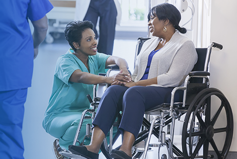 Nurse speaking with patient on a wheelchair 