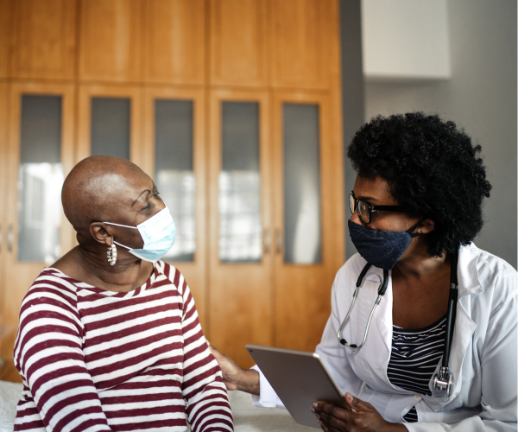 A cancer patient and her oncologist discuss the next steps in her treatment plan.